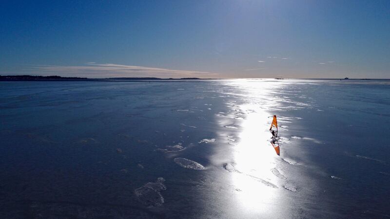 An ice surfer skates across the frozen Baltic Sea off the coast of Helsinki, the capital of Finland. AFP