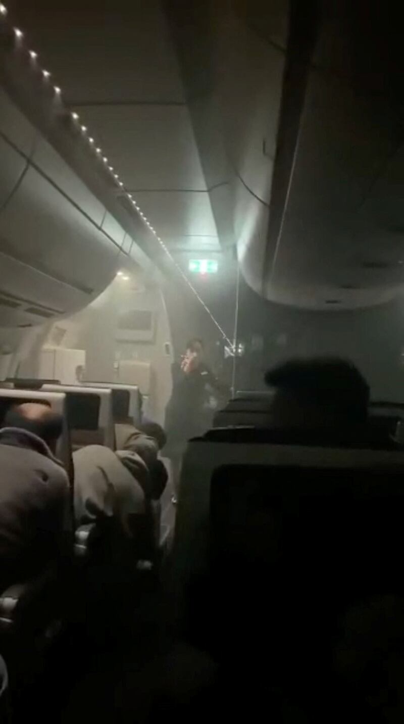 People sit in the smoke inside the Japan Airlines' A350. Reuters