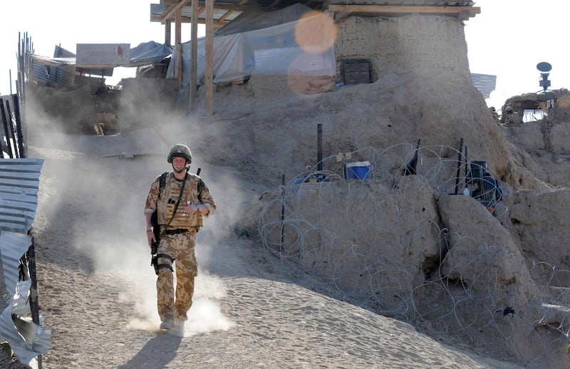 Britain's Prince Harry on patrol through the deserted town of Garmisir in January 2008, in Helmand province, Southern Afghanistan.  AP