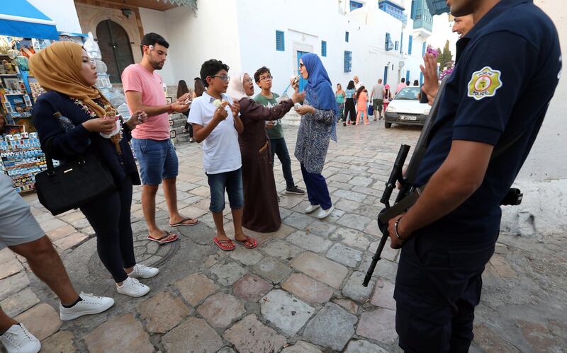 Police officers stand guard in Sidi bou Said town, 20km from Tunis, Tunisia. Sidi bou Said town is a popular tourist attraction, and is well known for the usage of white and blue colors for its buildings.  EPA