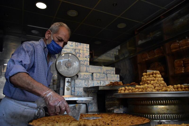 A Syrian readies Arabic sweets at Al Marjeh market ahead of Eid in the old city of Damascus, Syria, May 21. Youssef Badawi/ EPA