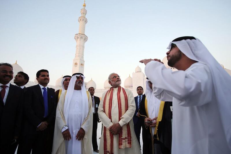 Mr Modi listens to a guide as he visits the Sheikh Zayed Grand Mosque with Sheikh Nahyan bin Mubarak during the first day of a two-day visit to the UAE. Kamran Jebreili / AP Photo