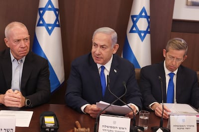 Israeli Defence Minister Yoav Gallant (left) with Prime Minister Benjamin Netanyahu (centre) and Cabinet Secretary Yossi Fuchs. EPA