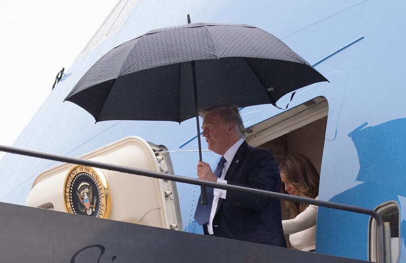 In this July 14, 2017, photo, President Donald Trump and first lady Melania Trump arrive on Air Force One at Newark Liberty International Airport, in Newark N.J., as they return from France. As Air Force One flew home from Europe, news was set to break about a meeting that Trumpâ€™s eldest son had with a Kremlin-connected lawyer, promising yet another round of unwelcome headlines about the president and Russia. The day-after-day drip-drip-drip of revelations over the past week about Donald Trump Jr.â€™s contact with the Russian lawyer in 2016 underscores the White Houseâ€™s inability to shake off the Russia story and close the book on a narrative that casts a shadow over Trumpâ€™s presidency.(AP Photo/Carolyn Kaster)