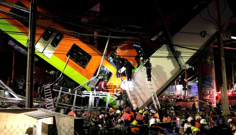 Rescuers work at a site where an overpass for a metro partially collapsed with train cars on it at Olivos station in Mexico City. Reuters