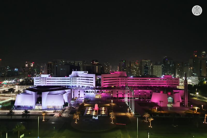 Abu Dhabi Municipality is illuminated in the maroon and white of the Qatari flag.