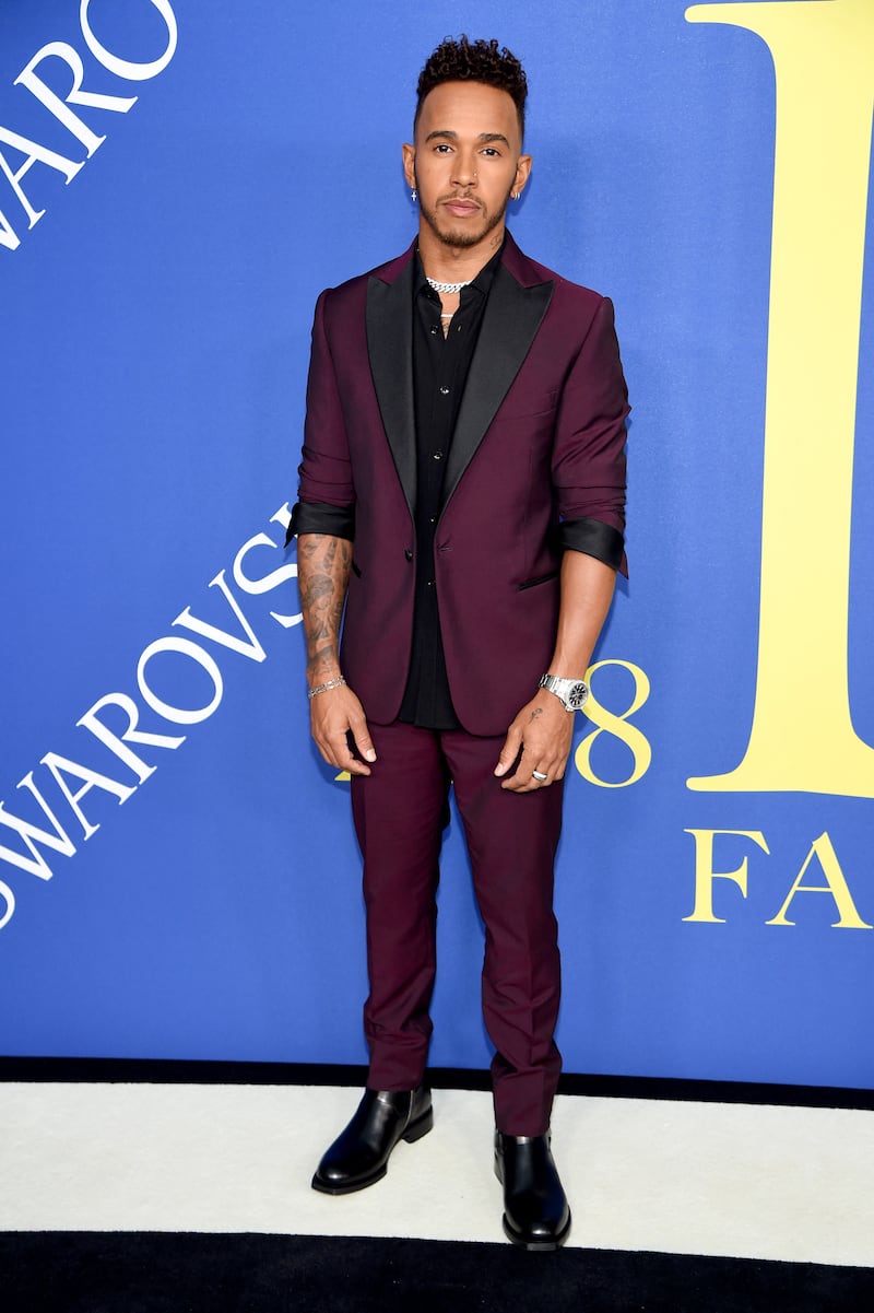 Lewis Hamilton, in a burgundy suit, attends the CFDA Fashion Awards at Brooklyn Museum on June 4, 2018. AFP