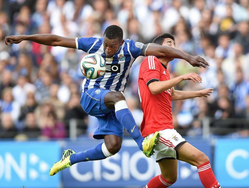 Porto's Colombian forward Jackson Martinez, left, vies with Benfica defender Andre Almeida during the Portuguese League Cup semi-final second leg match at the Dragao stadium in Porto on April 27, 2014. Francisco Leong / AFP