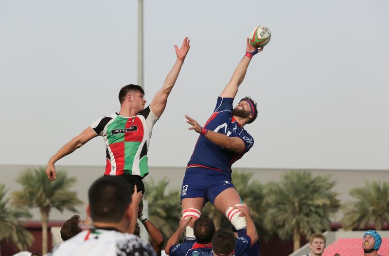 Dubai,UAE, April 7, 2017,  Abu Dhabi Harlequins (red and green) VS. Jebel Ali Dragons (Blue) Premiership final. (L-R) Patrick Jenkinson and Andy Buist reach for the ball.
Victor Besa for The National
ID: 38294
Reporter:  Paul Radley
Sports *** Local Caption ***  VB_040717_sp-rugby-1.jpg