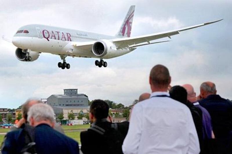 A Qatar Airways Boeing 787 Dreamliner takes part in a flying display at the Farnborough International Airshow in Hampshire, southern England, on July 9, 2012. Boeing upstaged European rival Airbus at the opening of the Farnborough air show on Monday, with a $7.2-billion order for 75 of its upcoming 737 MAX jets from a US leaser.  AFP PHOTO / CARL COURT