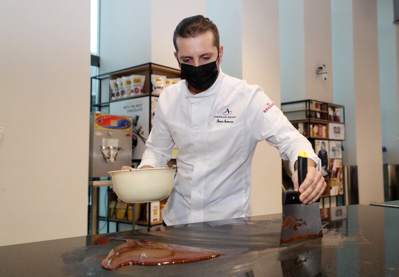 Chef Panagiotis Samaras tempers some chocolate at the opening.