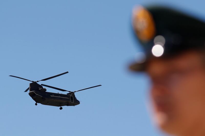 epa06894157 A CH-47SD Chinook flyby during the AH-64E Helicopters of Taiwan Army 601st Aviation Brigade Commission Ceremony in Taoyuan City, Taiwan, 17 July 2018. The 30 AH-64E Apache attack helicopters purchased by the Taiwan National Defense from the United States completed in October 2018.  EPA/RITCHIE B. TONGO