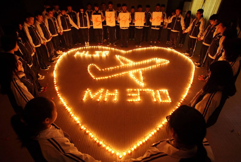 Pupils at the Hailiang International School light candles to pray for the missing Malaysia Airlines flight MH370 in China, in March 2014. AFP