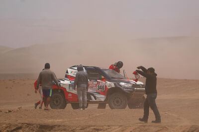 UNSPECIFIED, PERU - JANUARY 09:  Andre Villas Boas of Portugal and Overdrive Toyota and his co-driver Ruben Faria of Portugal climb back into their Toyota Overdrive car in the Classe : T1.1 : 4x4 Essence during stage four of the 2018 Dakar Rally, a loop stage to and from San Juan de Marcona on January 9, 2018 in UNSPECIFIED, Peru.  (Photo by Dan Istitene/Getty Images)