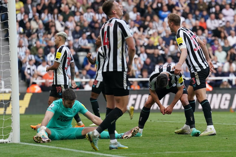 Newcastle United’s Fabian Schar, second from right, reacts after scoring an own goal to put Arsenal 2-0 ahead. PA 