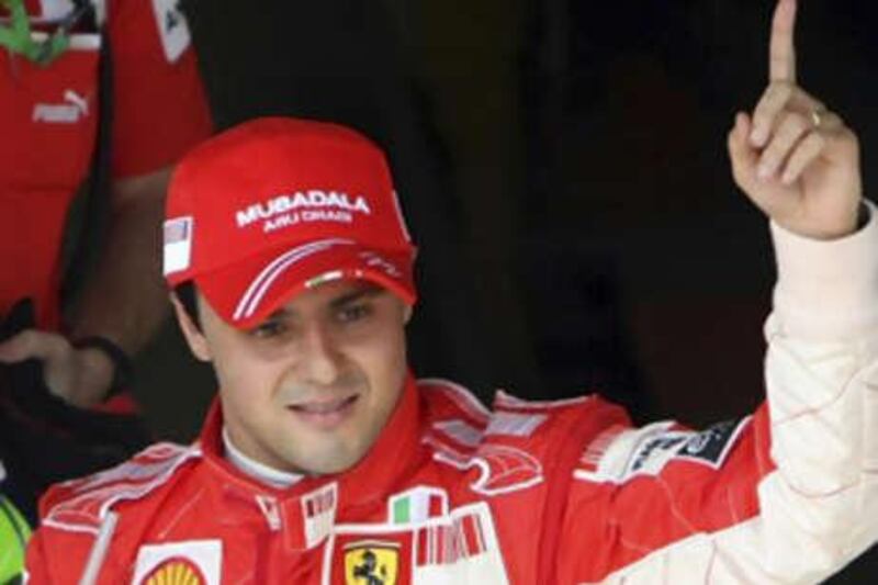 Ferrari's Felipe Massa celebrates taking pole position after the qualifying session for Sunday's Brazilian Grand Prix.