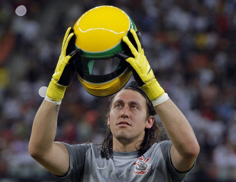 Corinthians goalkeeper Cassio Ramos holds up a replica of Ayrton Senna's helmet before his team's match against Nacional on Wednesday. Bruno Kelly / Reuters / April 30, 2014