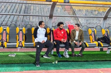 Liverpool striker Mo Salah wearing protective a boot as he watches Egypt train in Cairo. Egyptian FA