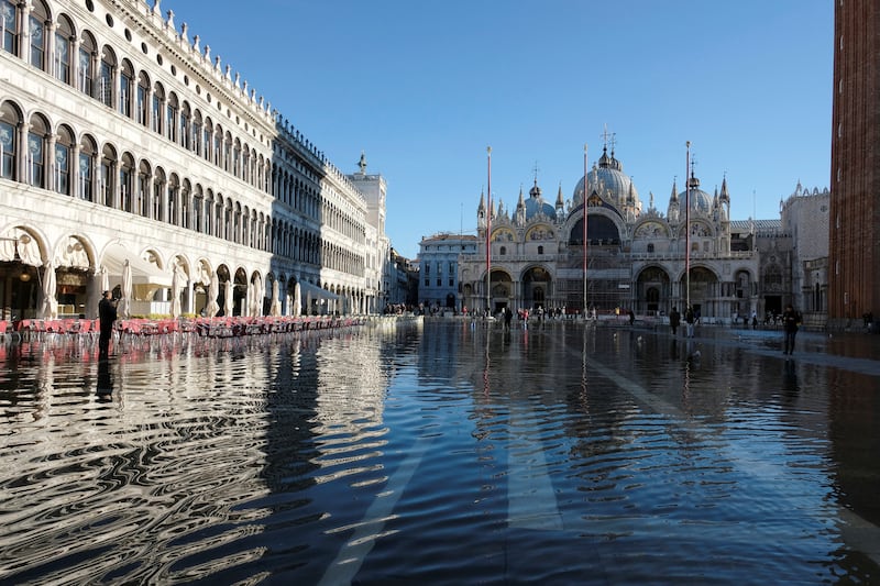 People wade through water on a flooded St.  Mark's Square during seasonal high water in Venice, Italy, November 6, 2022.  REUTERS / Manuel Silvestri