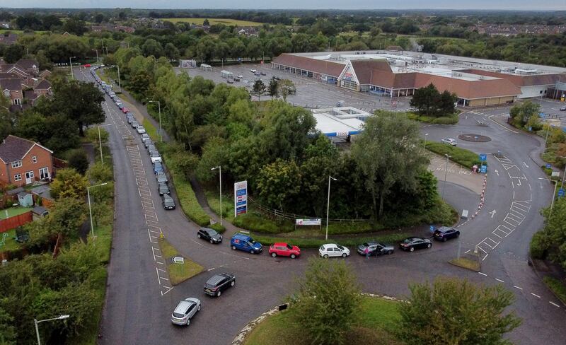 Motorists queue for a petrol station to open at a Tesco in Ashford, Kent on October 3