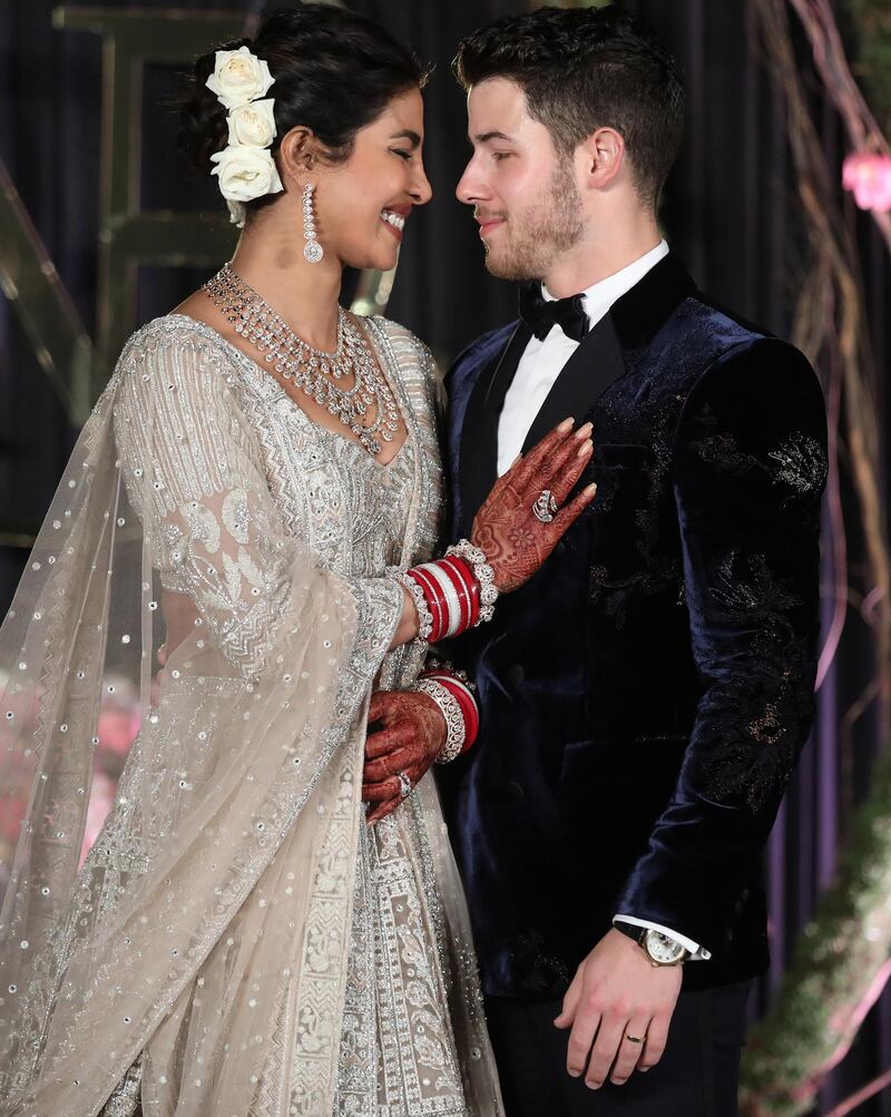 Newlyweds Priyanka Chopra, 36, and Nick Jonas, 26, pose for a photograph during a reception at a hotel in New Delhi on December 4, 2018. Photo: EPA