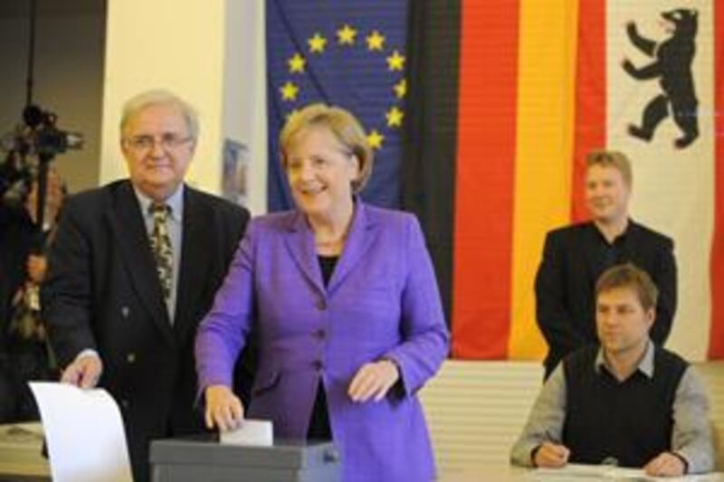 German Chancellor Angela Merkel, second left, casts her ballot for the European Elections on June 7, 2009 at a polling station in Berlin.