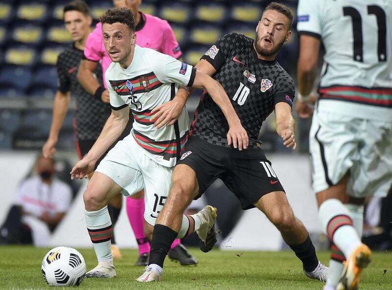 Portugal's forward Diogo Jota (L) challenges Croatia's midfielder Nikola Vlasic during the UEFA Nations League A group 3 football match between Portugal and Croatia at the Dragao Stadium in Porto on September 5, 2020. (Photo by MIGUEL RIOPA / AFP)