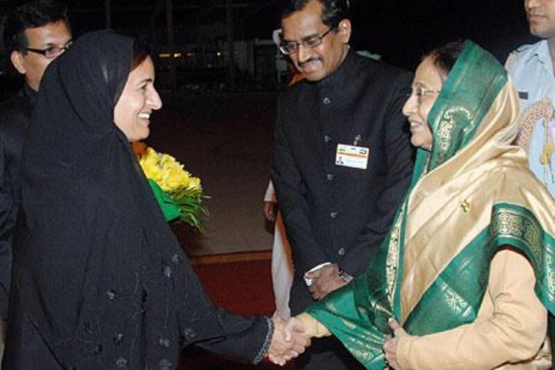 Indian President Pratibha Patil, right, is welcomed to Abu Dhabi by Foreign Trade Minister Sheikha Lubna Al Qasimi.