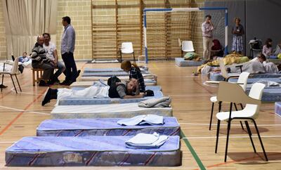 epa07082343 People prepare to spend the night at the Manacor's Miguel Angel Nadal sports centre after they have been evacuated because a torrent overflows causing three people dead at Sant Llorenc des Cardassar in Mallorca, Balearic Islands, Spain, 09 October 2018.  EPA/ATIENZA