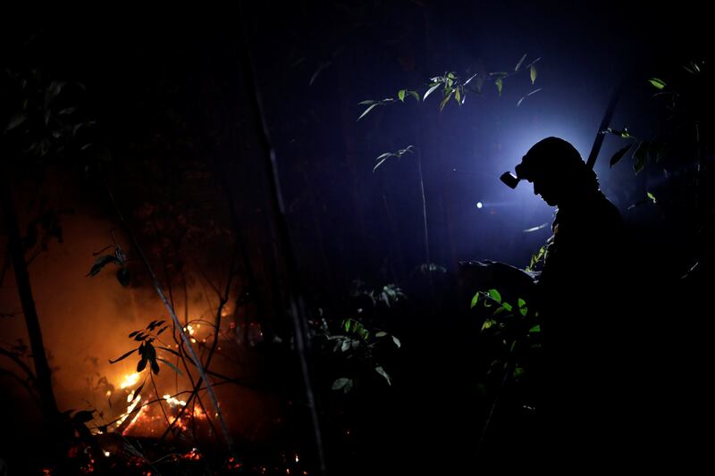 A volunteer works to put out a forest fire in the northern area of Brasilia's National Park, in Brasilia, Brazil. Ueslei Marcelino / Reuters