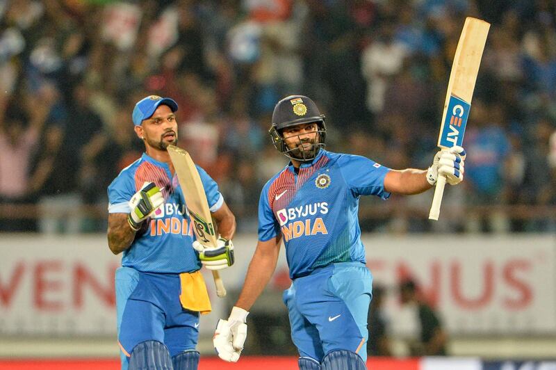 India's T20 captain Rohit Sharma (R) raises his bat after he completed his half century (50 runs) during the second T20 international cricket match of a three-match series between Bangladesh and India at Saurashtra Cricket Association Stadium in Rajkot on November 7, 2019. ----IMAGE RESTRICTED TO EDITORIAL USE - STRICTLY NO COMMERCIAL USE-----
 / AFP / Sajjad HUSSAIN / ----IMAGE RESTRICTED TO EDITORIAL USE - STRICTLY NO COMMERCIAL USE-----
