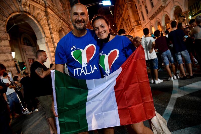 Italy fans celebrate in Genoa.