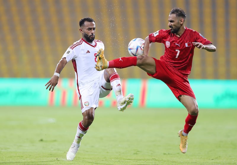 UAE's Tahnoon Al Zaabi and Bahrain's Ali Madan compete for the ball during the 2026 World Cup qualifying match in Dubai.