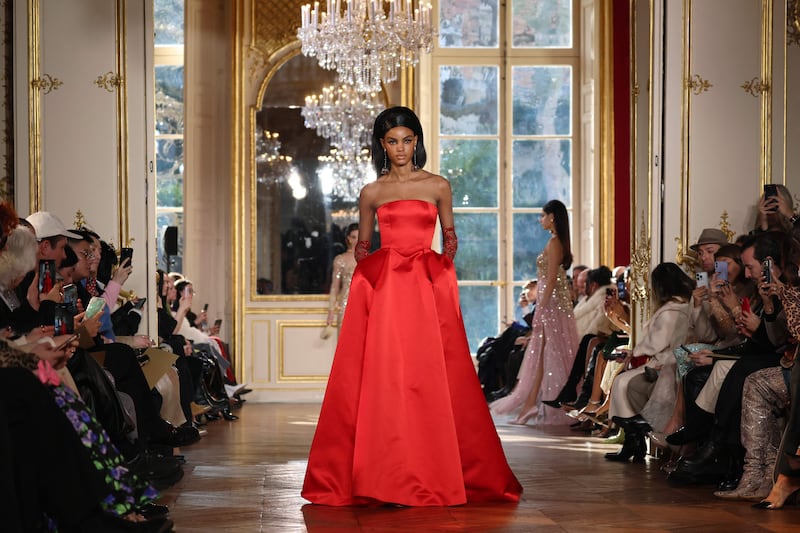 A strapless gown in glossy satin in a fiery shade of red. AFP