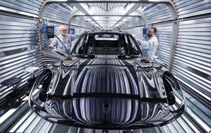 Workers assemble a Porsche Macan model on the production and quality control line of the Porsche plant in Leipzig. AFP