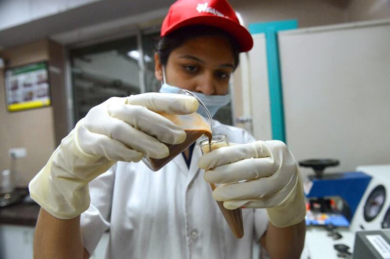 A quality control technician inspects a chocolate sample at the Havmor Ice Cream plant at Naroda near Ahmedabad in India. Sam Panthaky / AFP