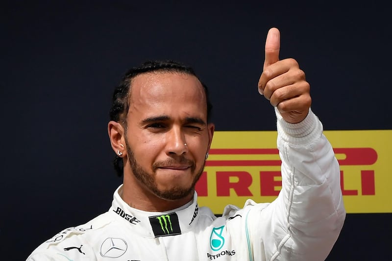 Winner Mercedes' British driver Lewis Hamilton celebrates on the podium after the Formula One Grand Prix de France at the Circuit Paul Ricard in Le Castellet, southern France, on June 23, 2019. / AFP / GERARD JULIEN
