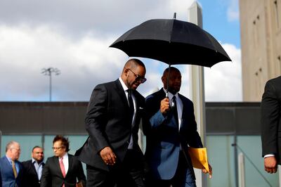 (FILES) In this file photo taken on March 22, 2019 US music artist R. Kelly (L) leaves the George N. Leighton Criminal Court Building after a hearing for his sex abuse case in Chicago, Illinois. Chicago prosecutors on May 30, 2019 filed 11 felony sex crime charges against R&B superstar R. Kelly, in what his lawyer said was a refiling of counts from an existing case. Kelly is already facing 10 felony charges, filed in February, for the alleged abuse of four women.  / AFP / Joshua Lott
