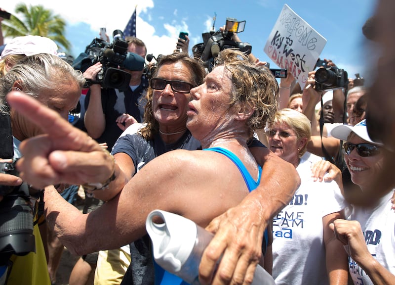 Endurance swimmer Diana Nyad, right, and her trainer, Bonnie Stoll hug after Nyad walks ashore Monday, Sept. 2, 2013 in Key West, Fla. after swimming from Cuba. Nyad became the first person to swim from Cuba to Florida without the help of a shark cage. She arrived at the beach just before 2 p.m. EDT, about 53 hours after she began her swim in Havana on Saturday.  (AP Photo/J Pat Carter) *** Local Caption ***  Cuba Swimming To Florida.JPEG-0338b.jpg