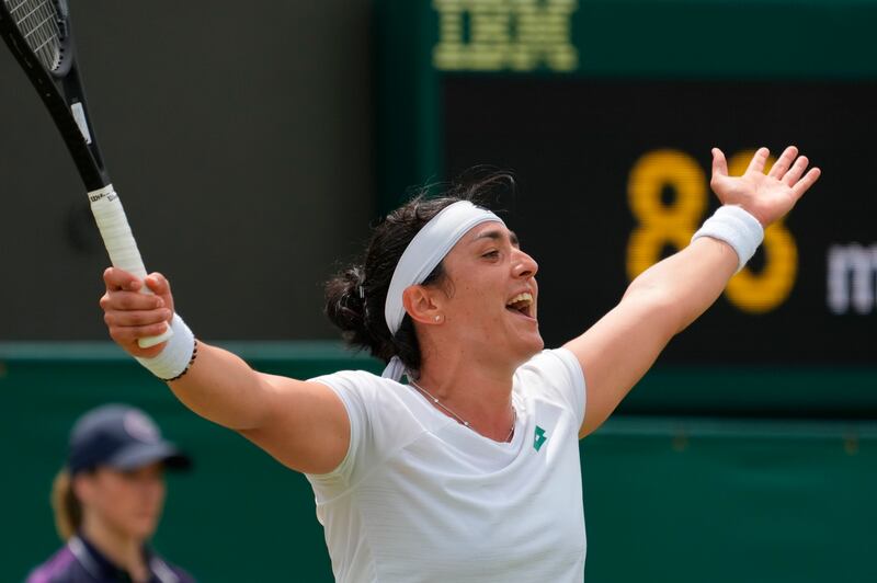 Tunisia's Ons Jabeur celebrates celebrates after defeating Poland's Iga Swiatek during the women's singles fourth round match on day seven of the Wimbledon Tennis Championships in London, Monday, July 5, 2021.  (AP Photo / Alberto Pezzali)