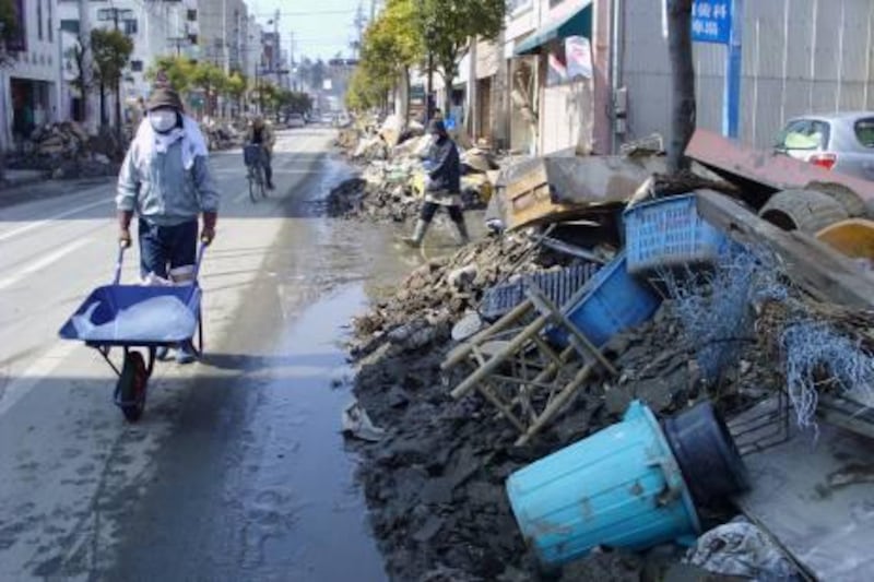 streets in Ishinomaki, a city in Miyagi prefecture in Japan, in mid-April, about a month after the March 11 tsunami. In one photo a volunteer is helping to clear rubbish. Photo Daniel Bardsley