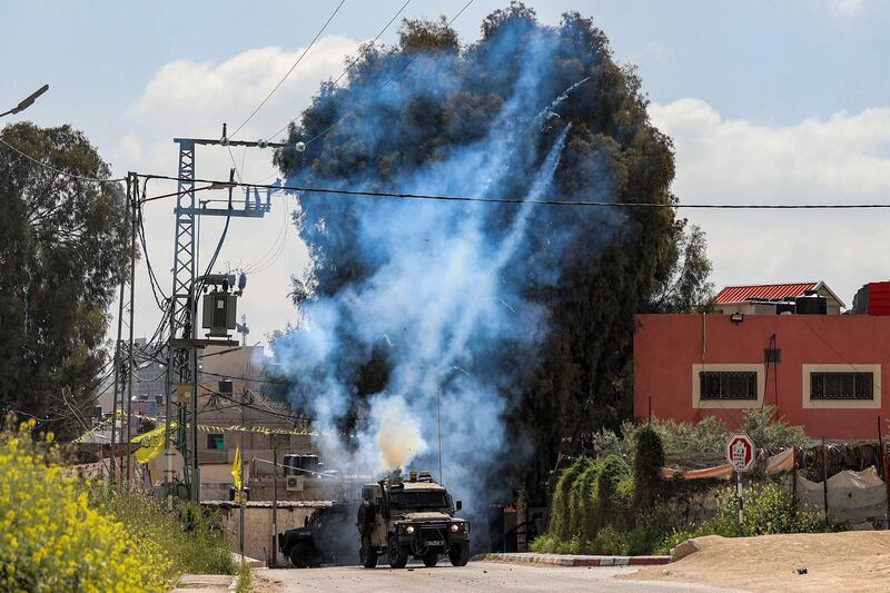 Tear gas canisters are fired from an Israeli military vehicle near the Palestinian refugee camp of Jenin in the occupied West Bank. AFP