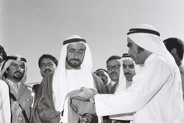 History Project 2010, "The First Day". Sheikh Zayed raising the flag at Union House in Dubai. December 2, 1971. Mahdi Tajer (right, need to confirm this) is shown handing the flag to Sheikh Zayed. Credit Ittihad Newspaper **EDS NOTE ***IMPORTANT** SEEK ADVISE FROM KAREN BEFORE USE