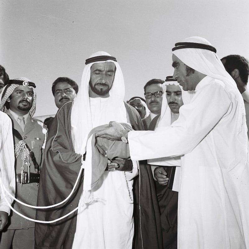 History Project 2010, "The First Day". Sheikh Zayed raising the flag at Union House in Dubai. December 2, 1971. Mahdi Tajer (right, need to confirm this) is shown handing the flag to Sheikh Zayed. Credit Ittihad Newspaper **EDS NOTE ***IMPORTANT** SEEK ADVISE FROM KAREN BEFORE USE