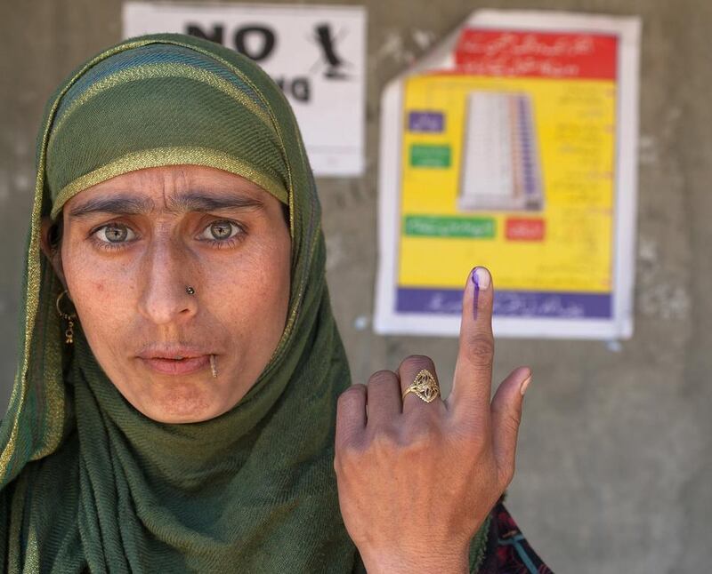 A Kashmiri Muslim woman show her indelible ink marked finger after casting her vote during the sixth phase of Indian parliamentary elections on in Vejbeour 45 km (28 miles) south of Srinagar. (Yawar Nazir / Getty Images / April 24, 2014)