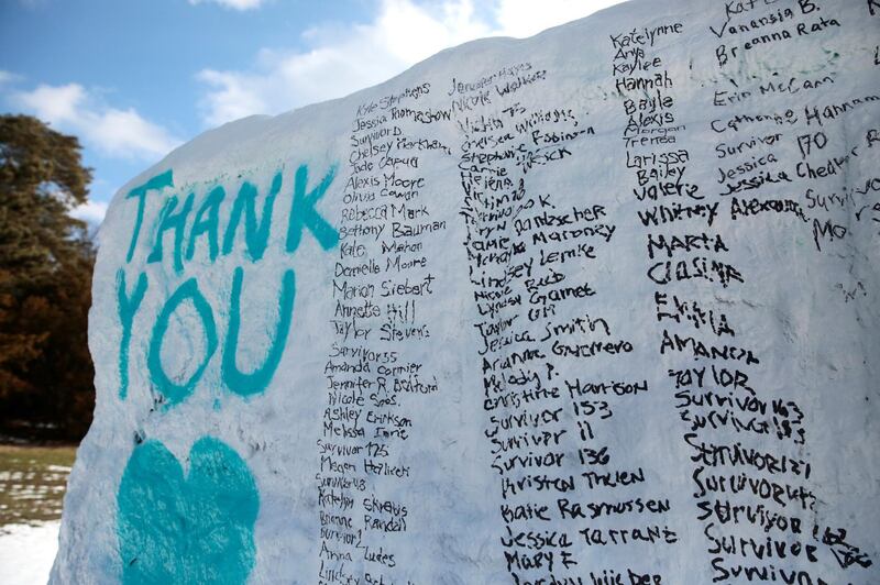 A boulder on the campus of Michigan State University "The Rock" is painted with the names of assault victims of Larry Nassar, a former team USA Gymnastics doctor who pleaded guilty in November 2017 to sexual assault, in East Lansing, Michigan, U.S., February 1, 2018.   REUTERS/Rebecca Cook