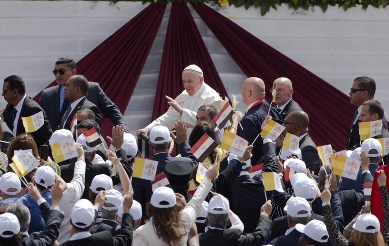 Pope Francis waves as he arrives to celebrate Mass for Egypt's Catholic community at the air defence stadium in Cairo. Amr Nabil / AP