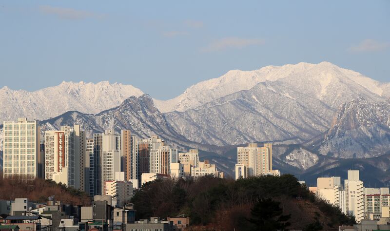 The ridge of Mount Seorak is seen from the city of Sokcho, South Korea, as the highest peak of the 1,708-meter mountain is covered with snow.   EPA
