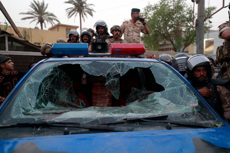 An Iraqi police car hit during clashes between protesters and riot police. AFP