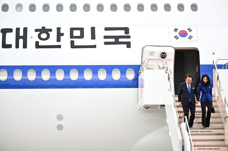 Yoon Suk Yeol, South Korean President, left, and his wife Kim Keon Hee arrive at Hiroshima Airport in Mihara for the G7 Summit. AFP